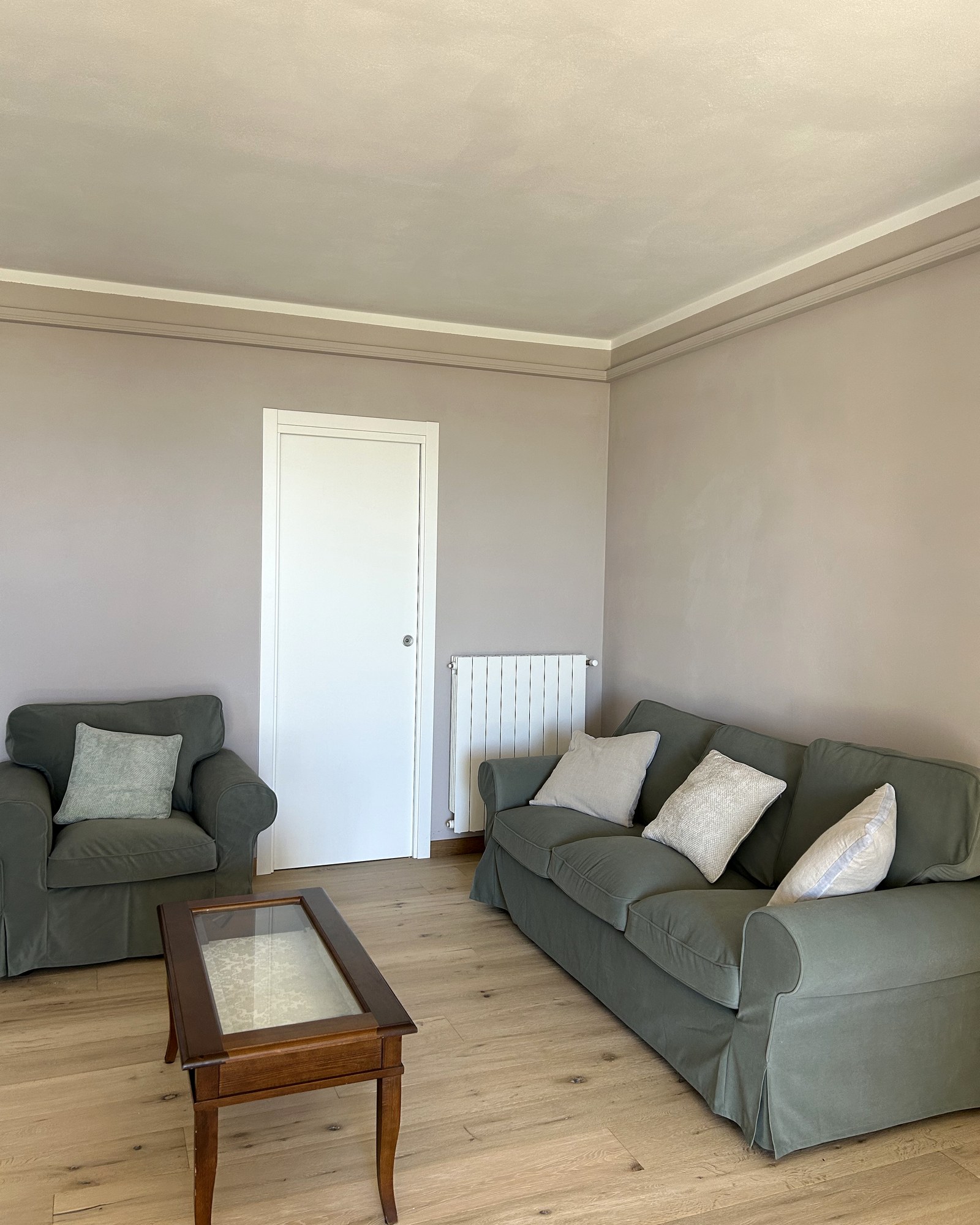 The living room with olive green sofa and armchairs