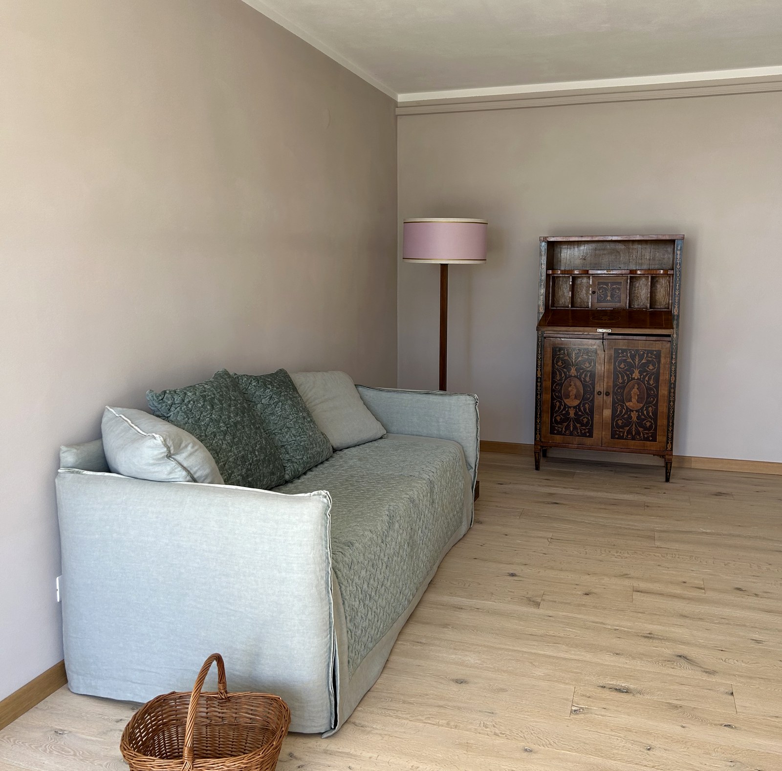 The upstairs sitting room with daybed sofa and antique cabinet